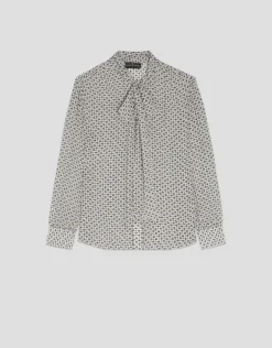 Blusa con lazada estampado geométrico blanco y negro