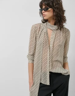 Blusa con lazada estampado geométrico blanco y negro