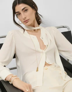 Blusón oversize cuello lazada crudo